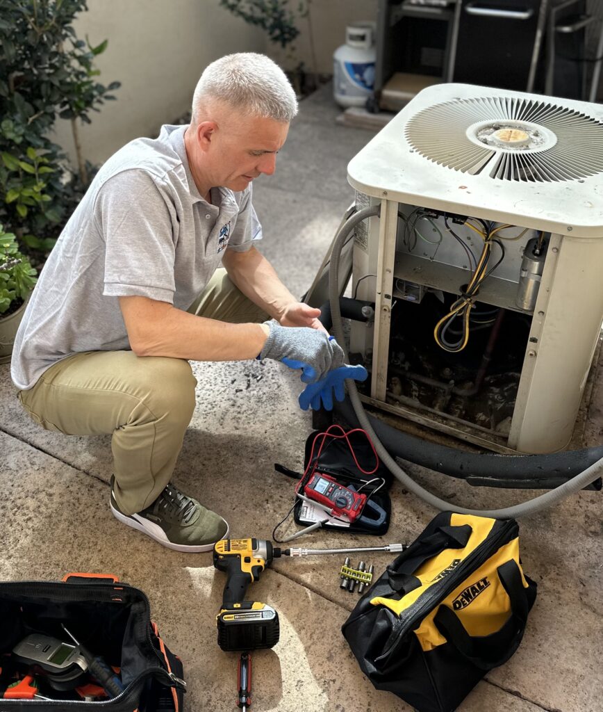 Silver Fox AC Repair Alex repairing an air conditioning